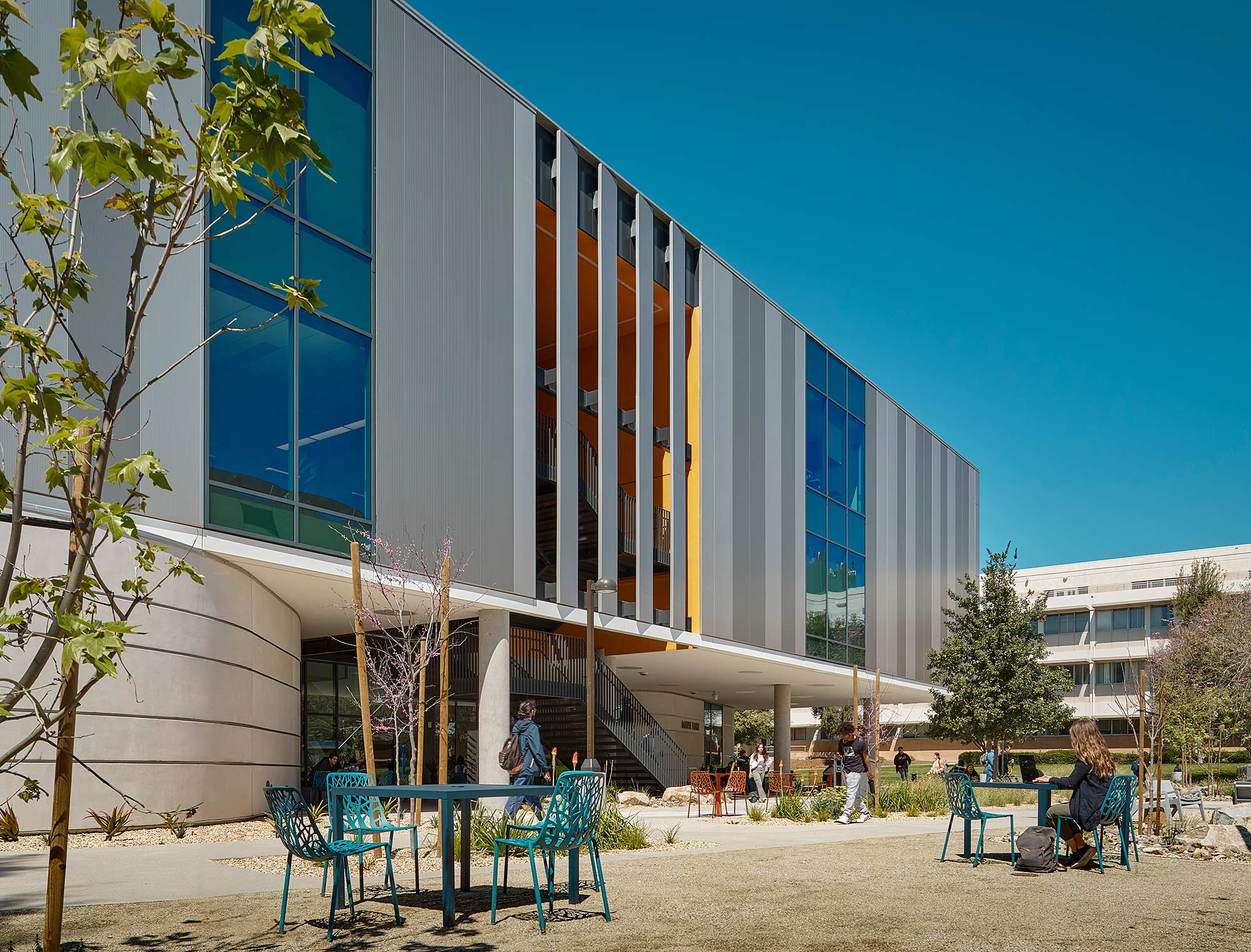 A building with a few people sitting outside.