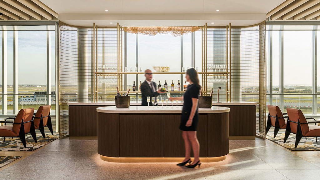 A woman standing in front of a counter with a man behind it.