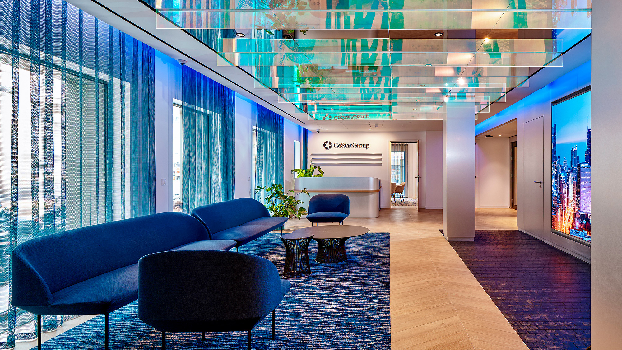 A room with blue chairs and a table.