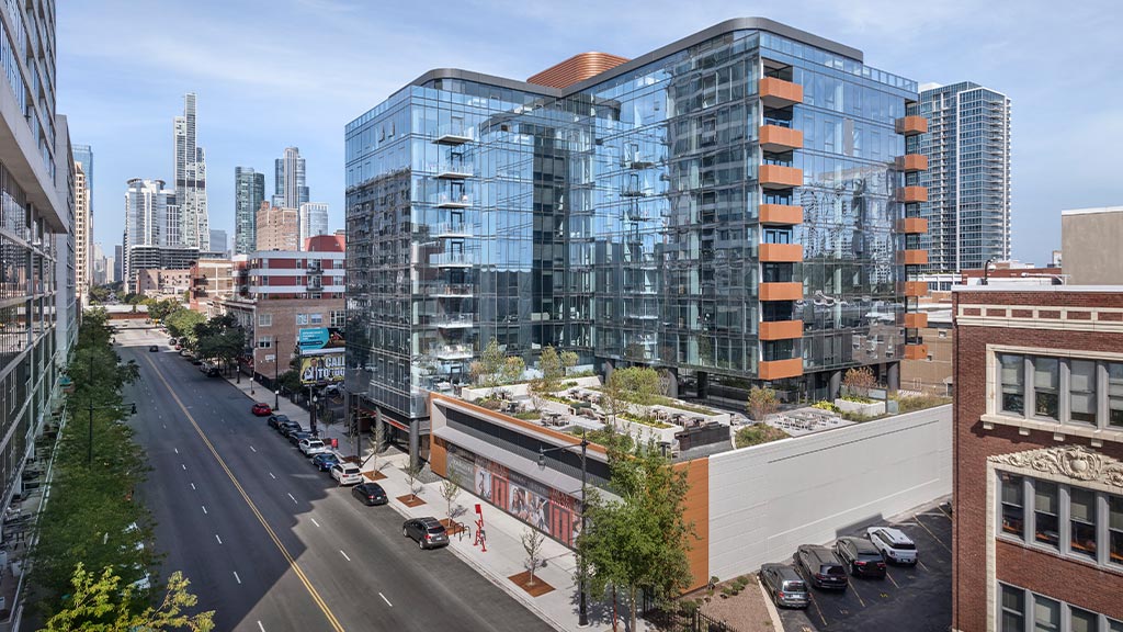 A street with cars and buildings along it.