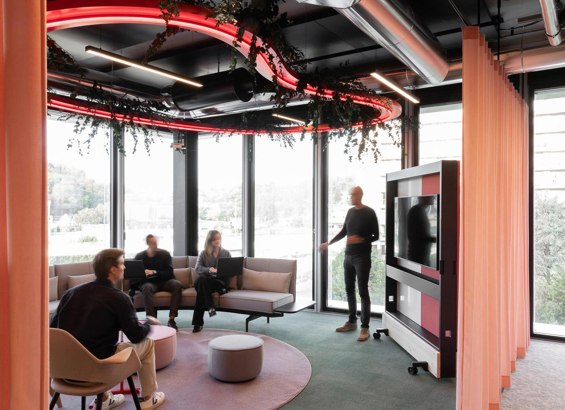 A group of people watching a television.