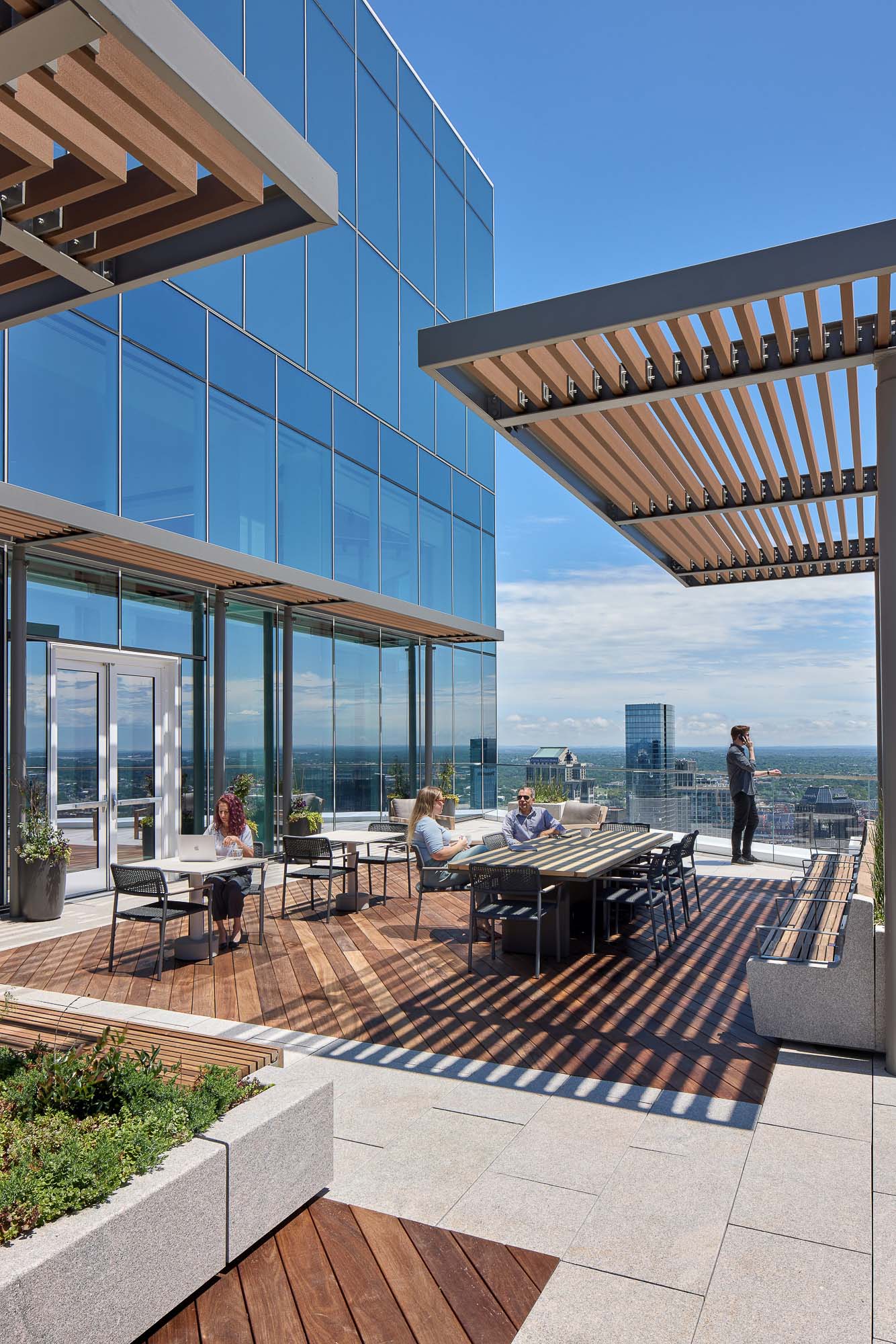 A group of people sitting outside a building.