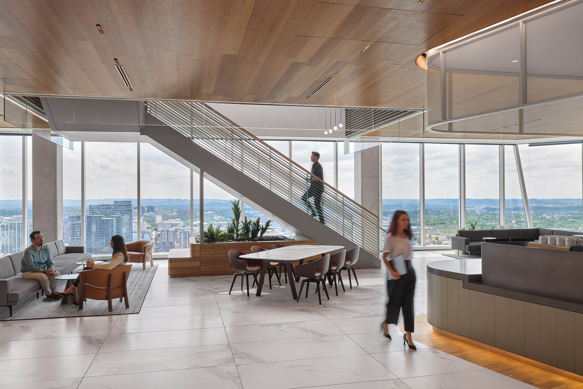 A person walking in a large room with a large glass ceiling.