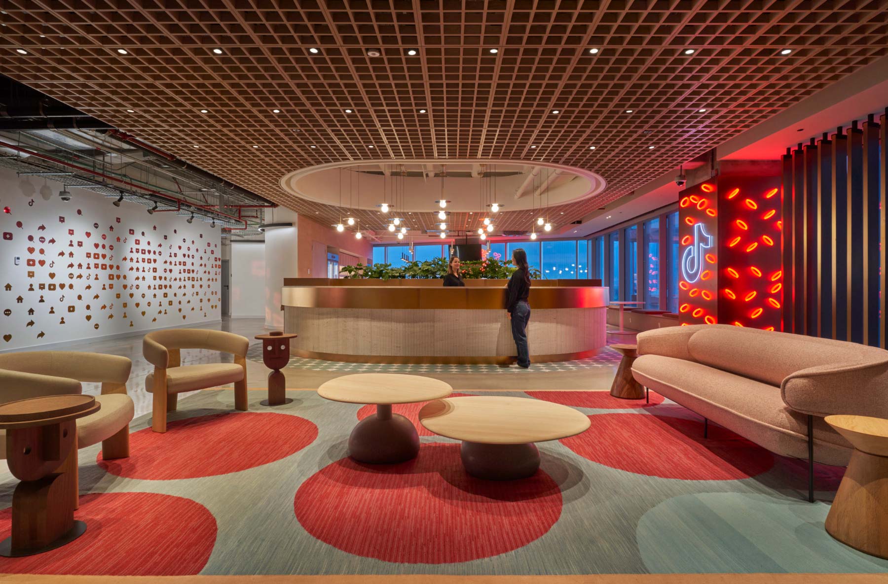 A person standing in a room with a large red and white floor.