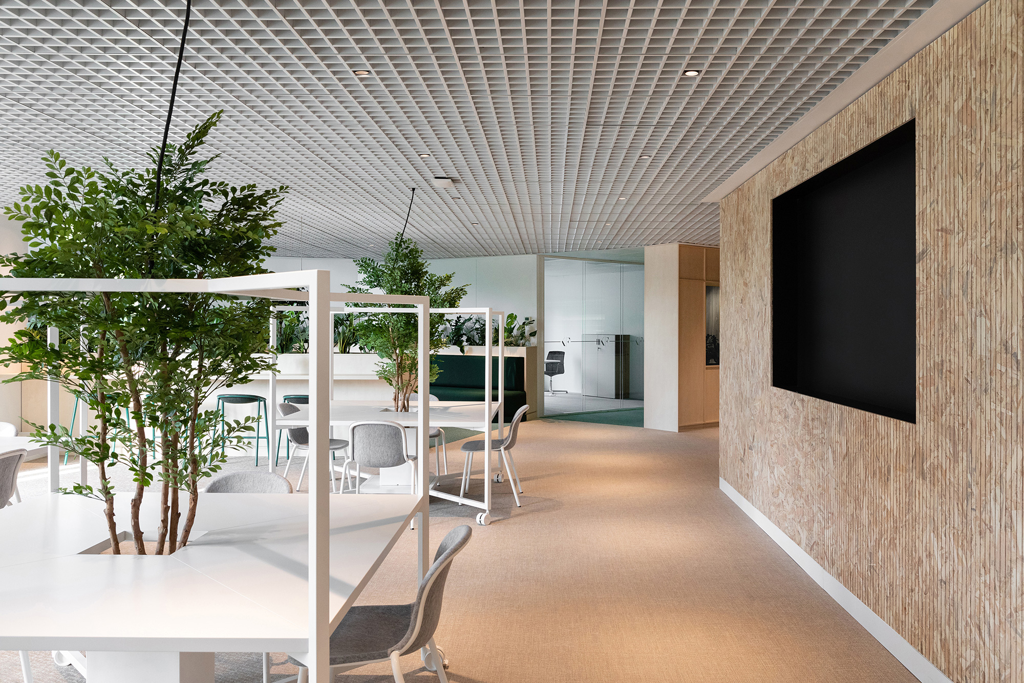 A room with a tv and chairs.