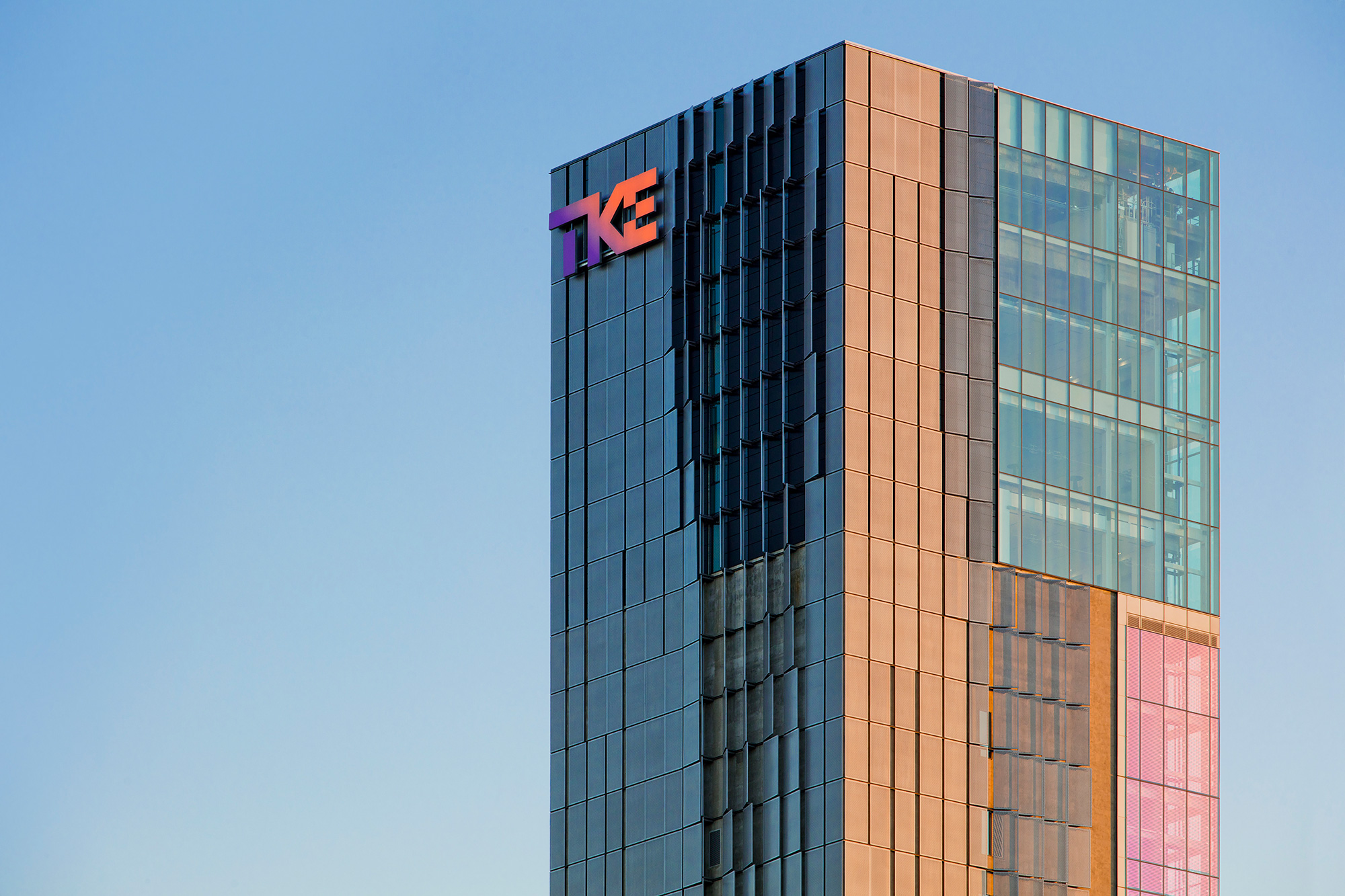 A tall building with a logo on it.