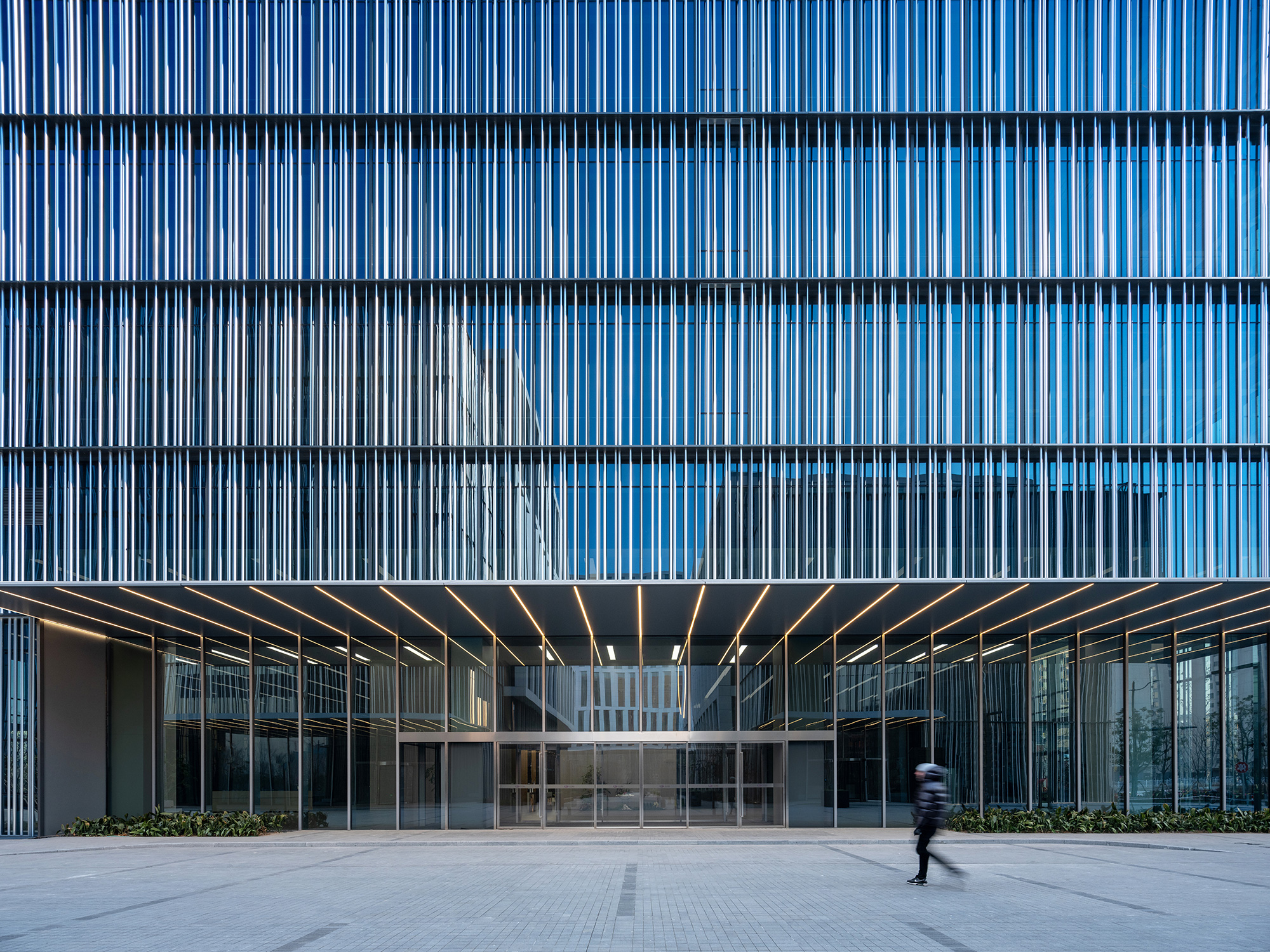 A person walking outside of a building.