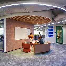 A person standing in front of a booth in a building.
