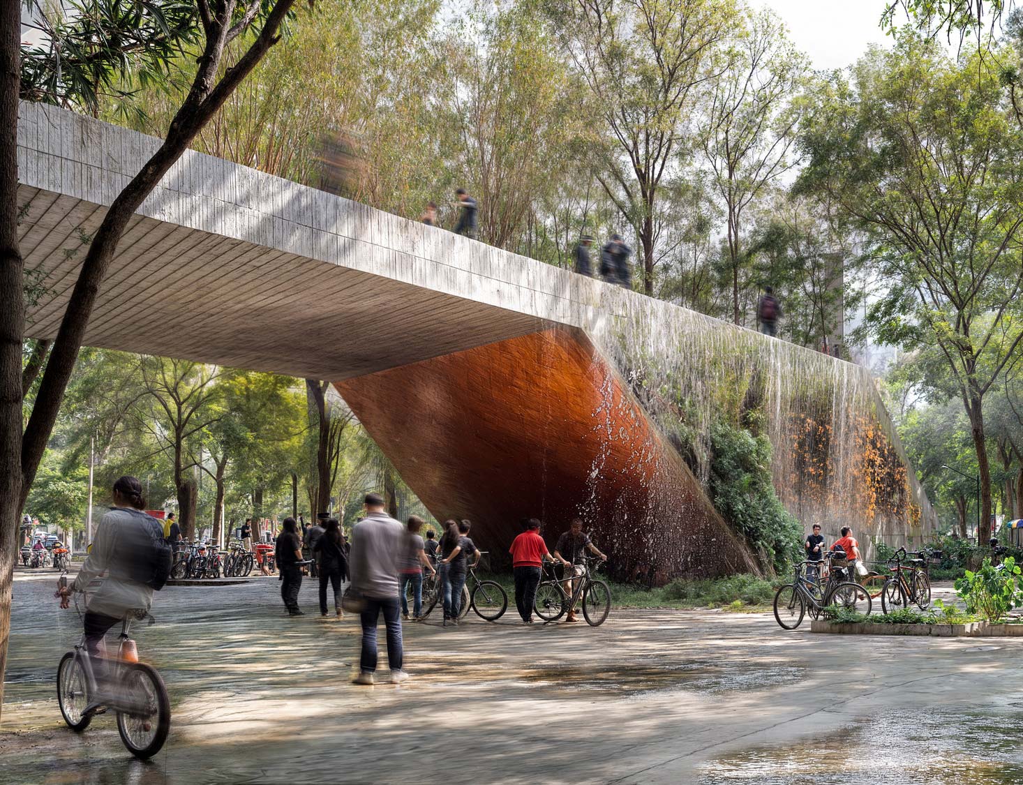 A group of people riding bikes under a bridge.