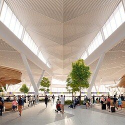 A large group of people walking inside a building.