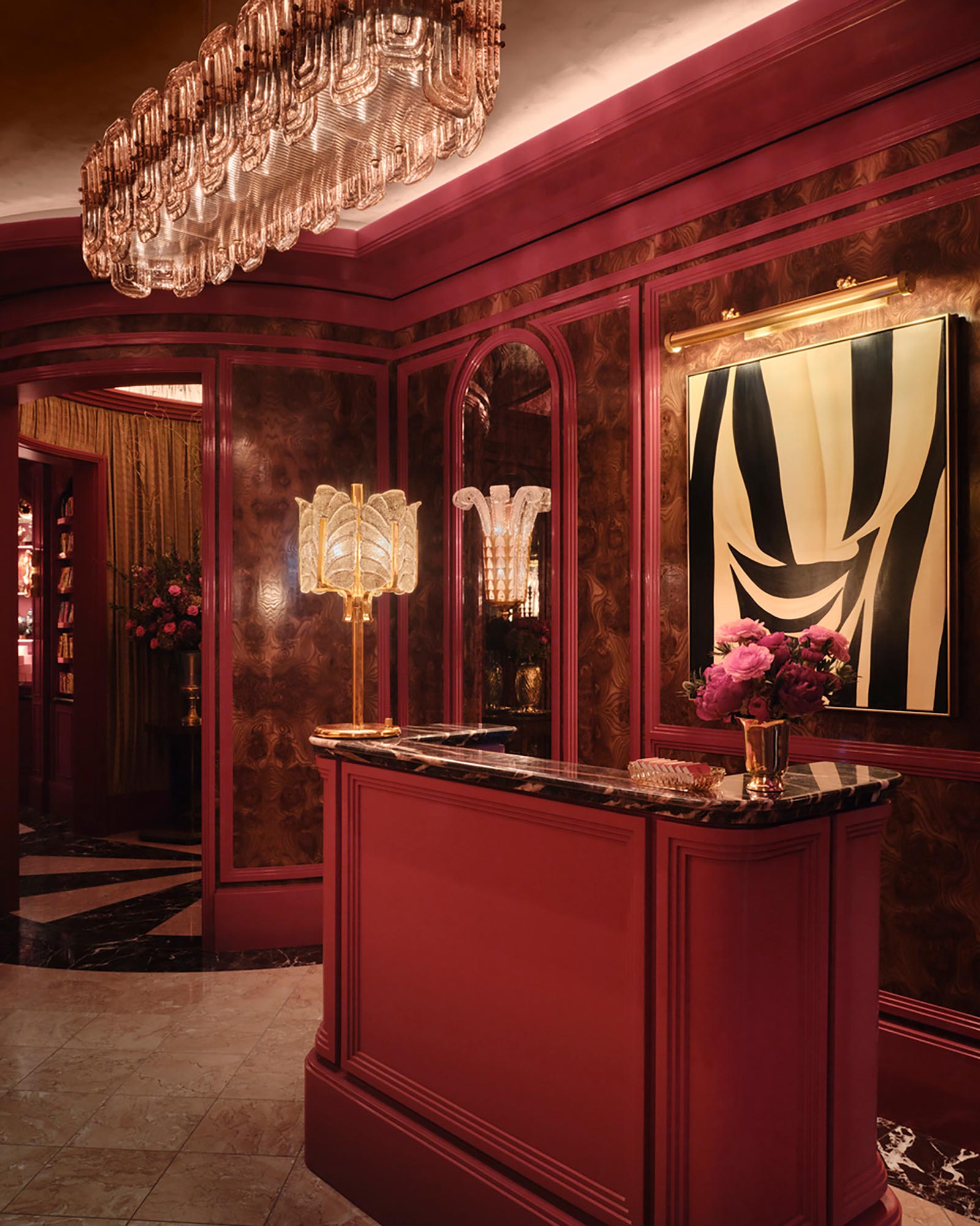 A room with a red wall and a mirror.