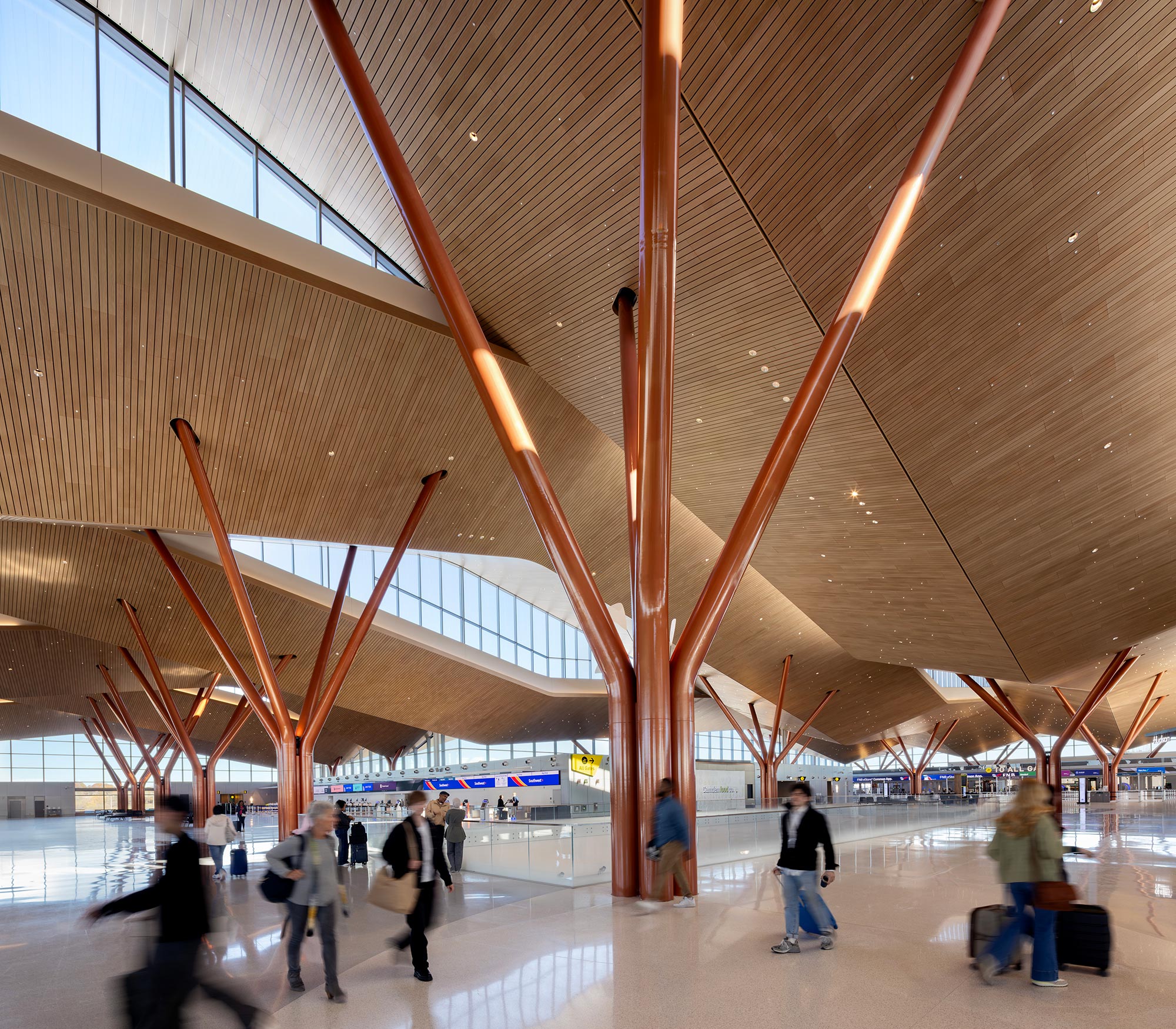 A group of people walking in a large building.