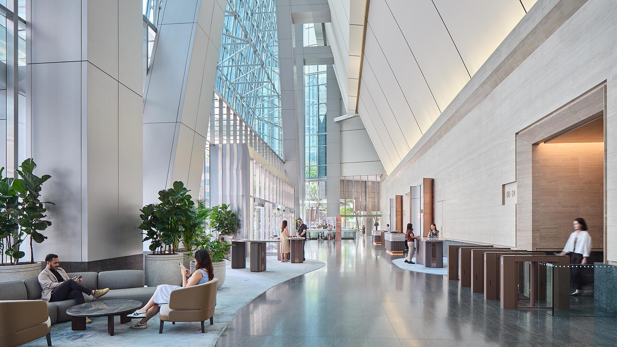 A group of people in a large room with glass walls.