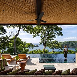 A person standing next to a pool.