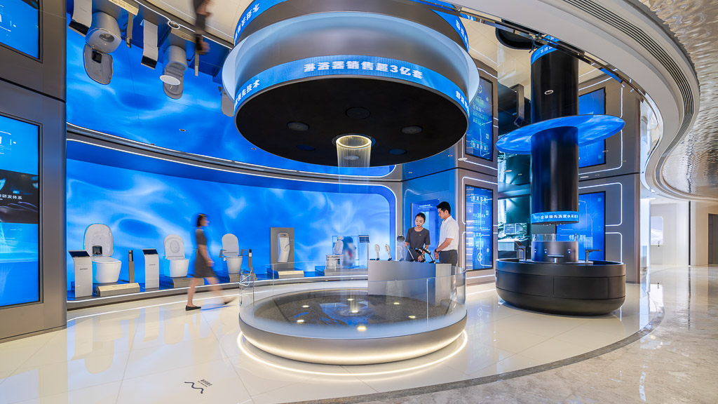 A room with a large glass wall and a few people standing in it.