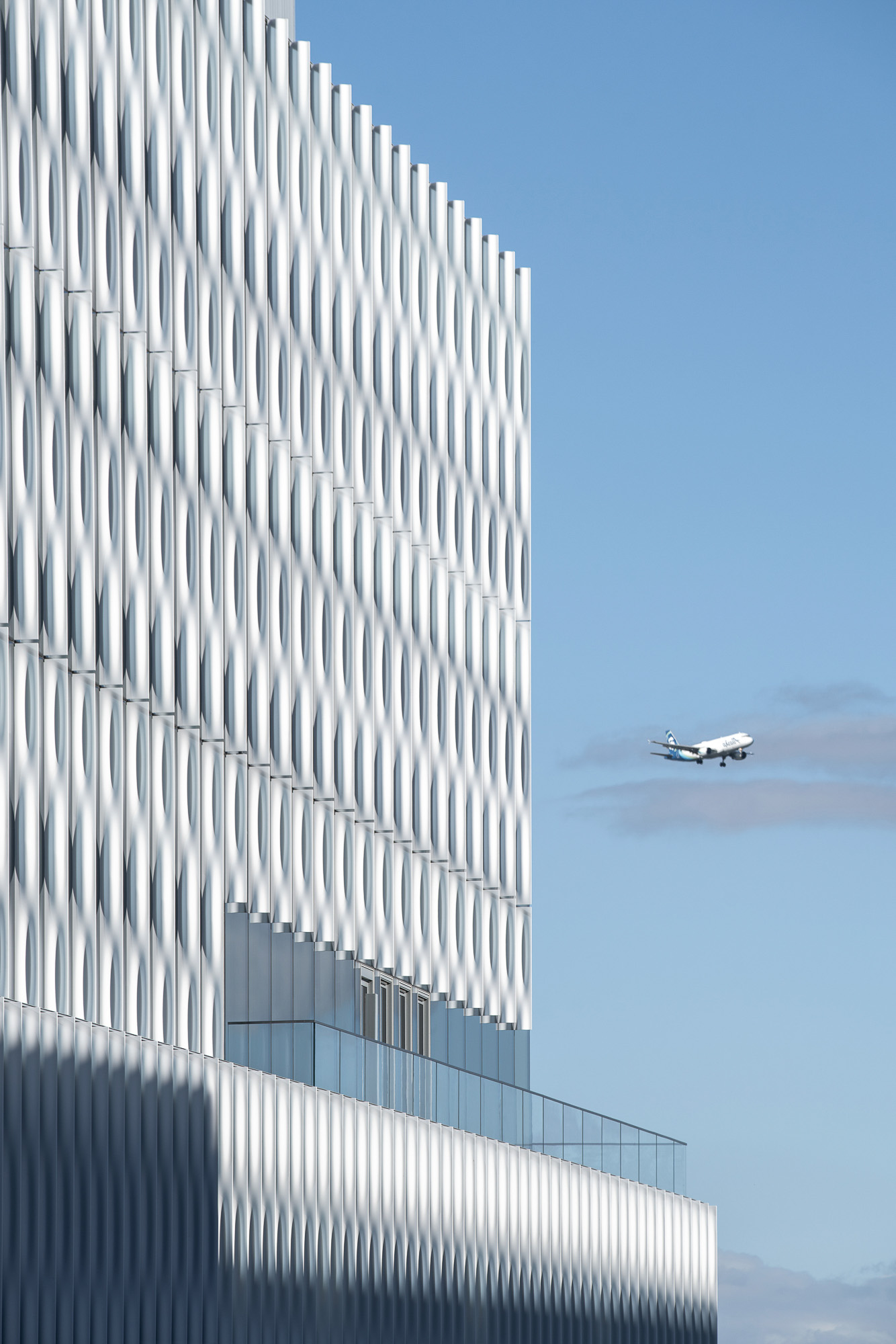 A plane flying over a building.