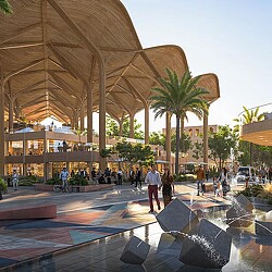 A large building with a large glass front and a group of people walking around.