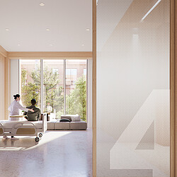 A couple of people sitting in a room with a couch and a table.