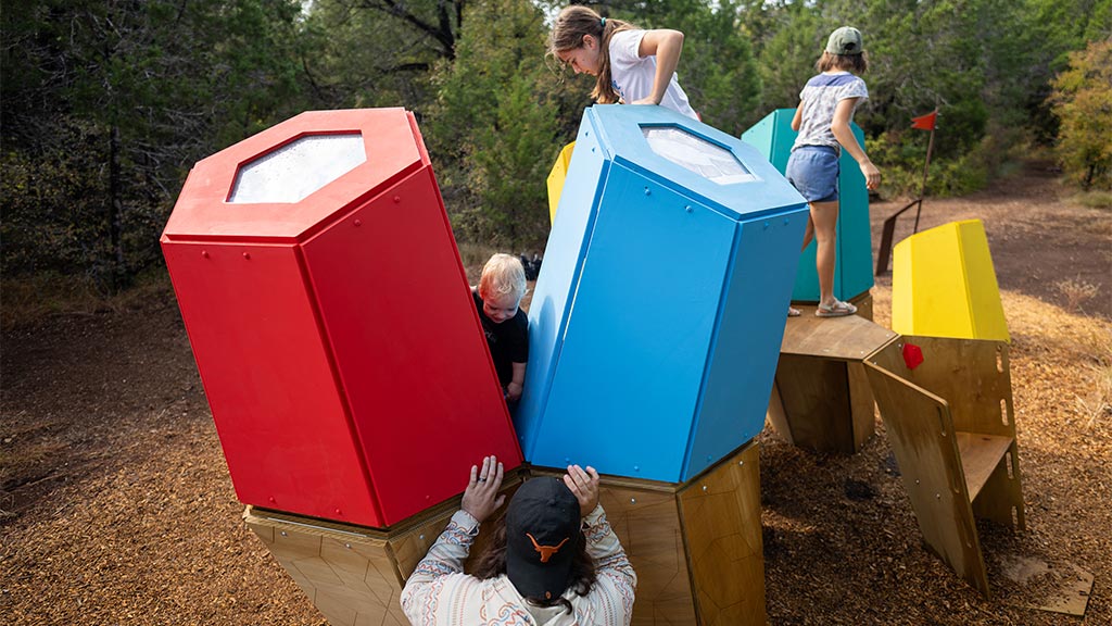 A group of people playing in a play area.