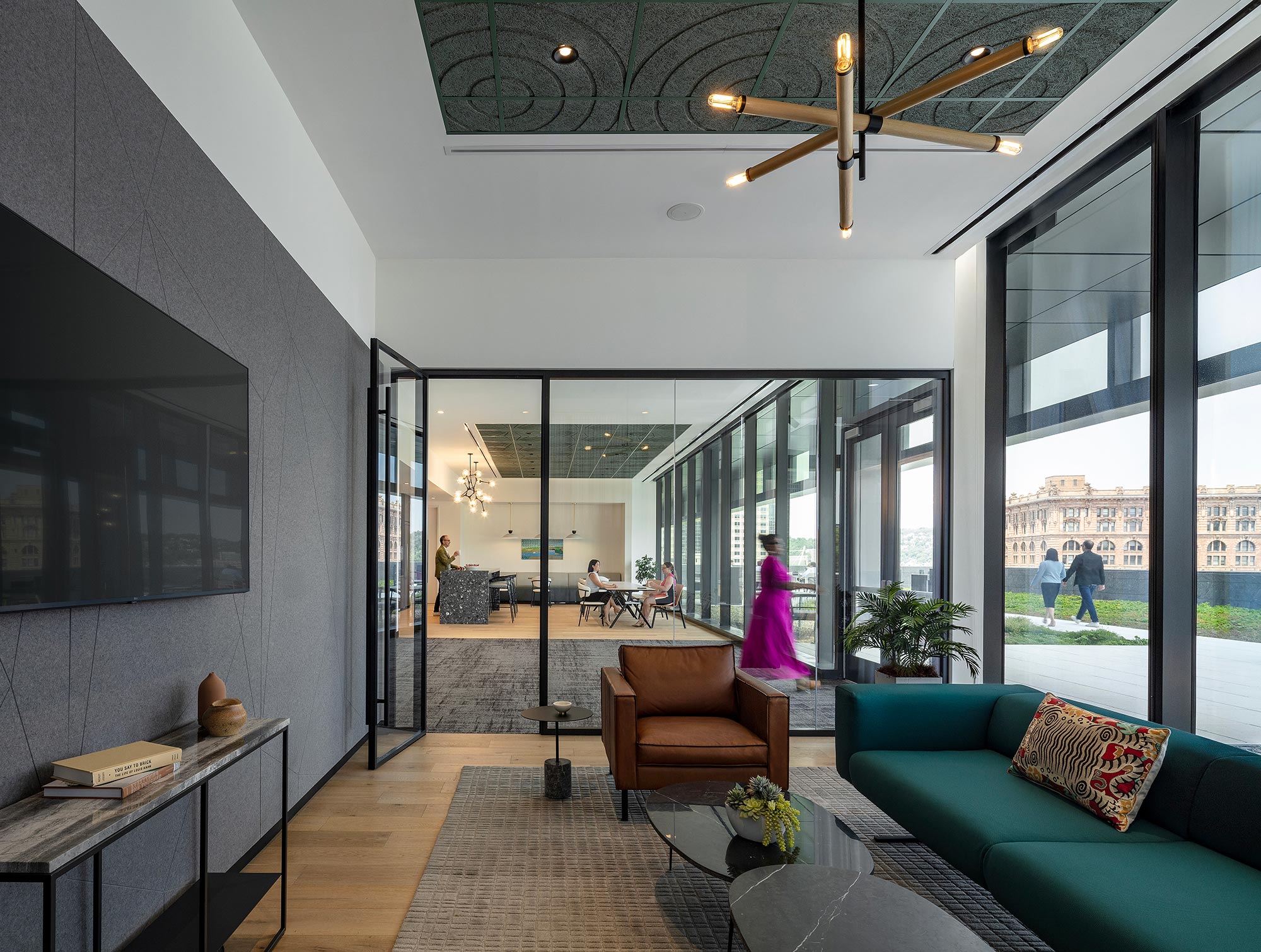 A person in a purple dress in a room with a large glass door.