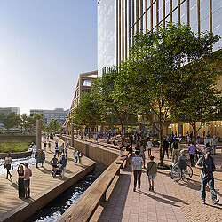 A group of people walking on a sidewalk next to a building.