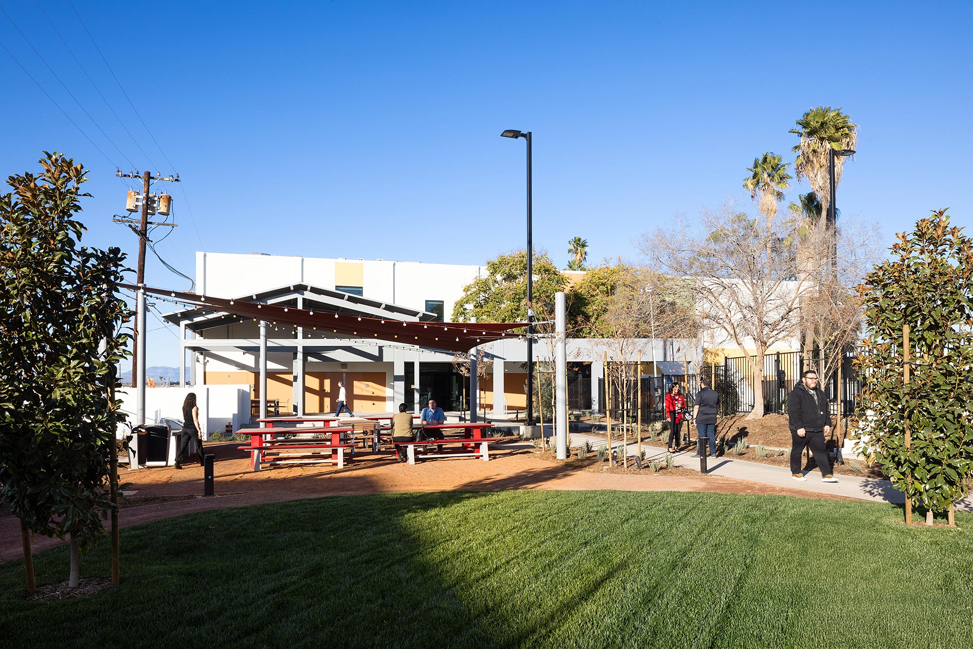 A building with a lawn and trees.
