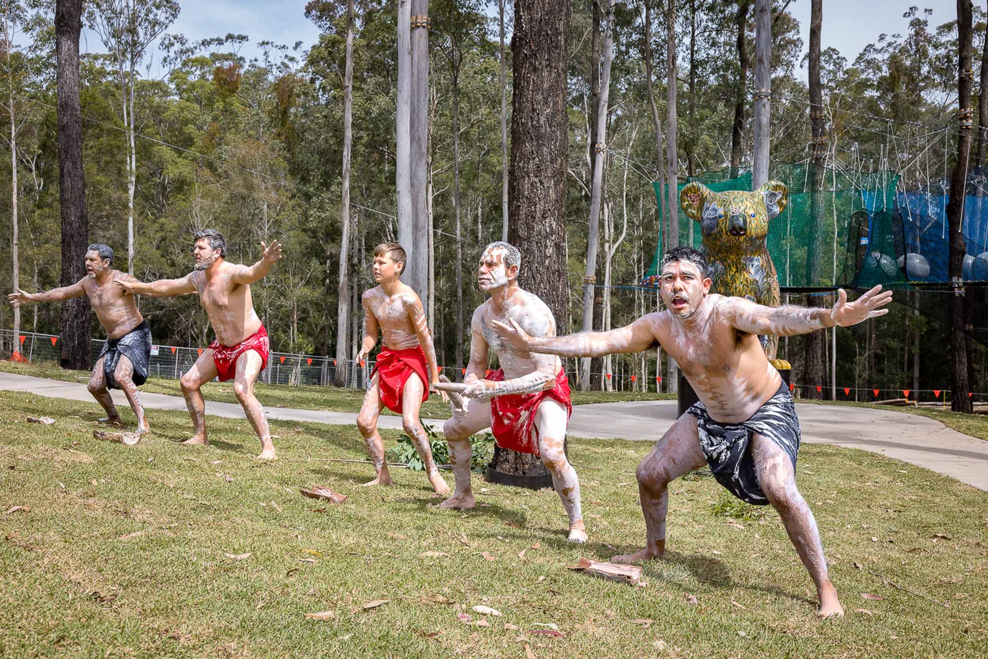 A group of men in shorts jumping in the air.