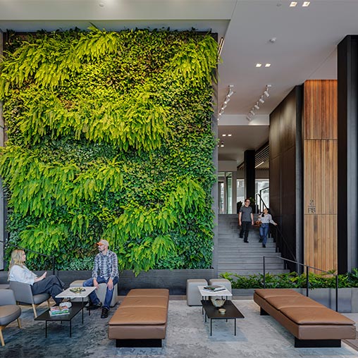 A group of people sitting on the stairs of a building.