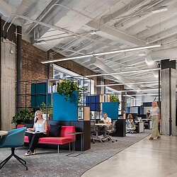 A person sitting on a red couch.
