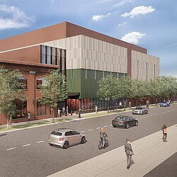 A building with a street and cars.