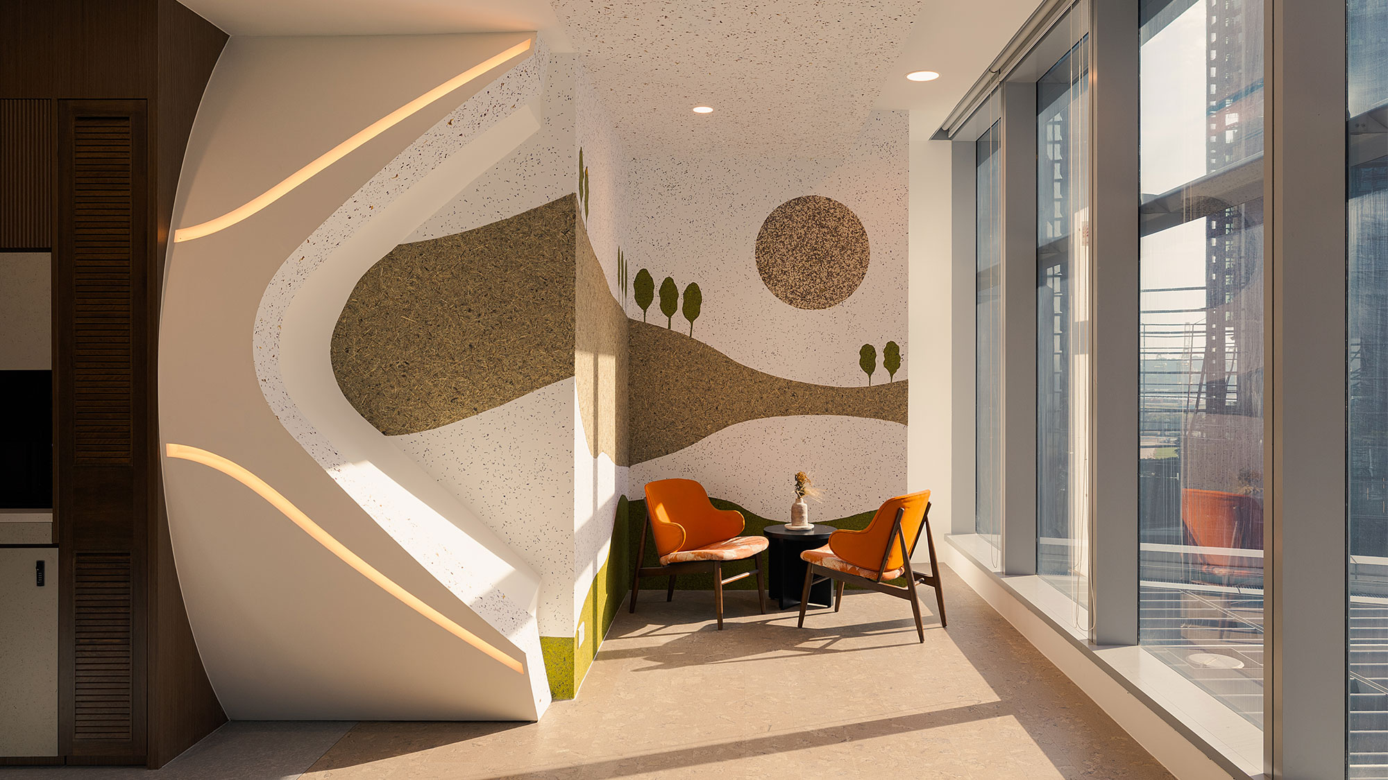 A room with a table chairs and a wall with a design on it.