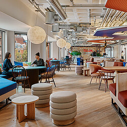 A group of people sitting at tables.