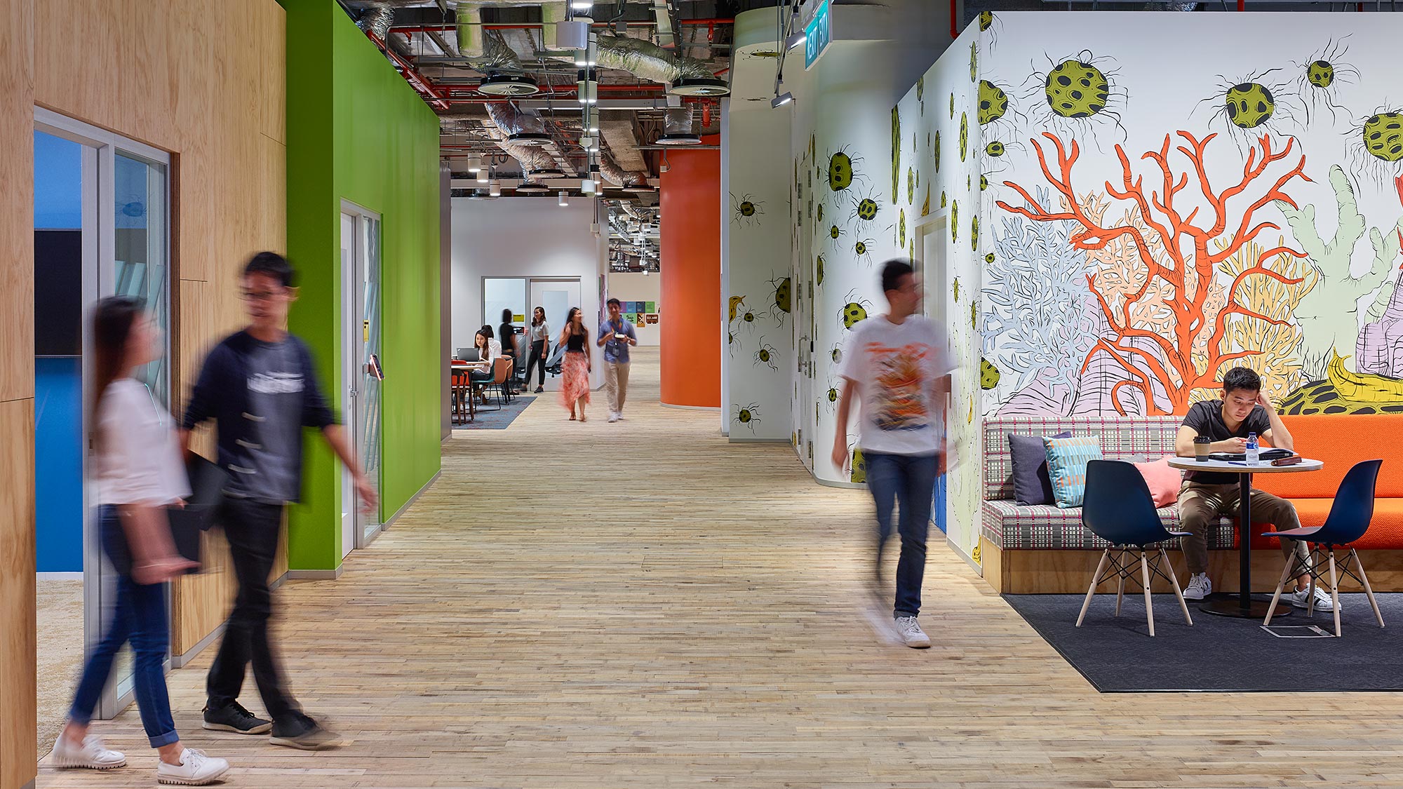 A group of people walking in a hallway.