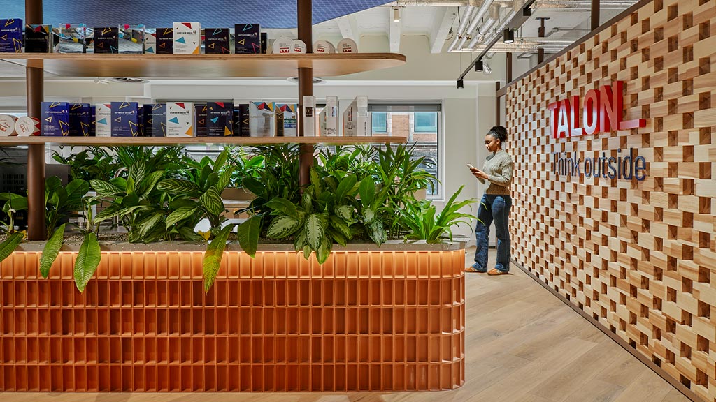 A person standing next to a table with plants on it.