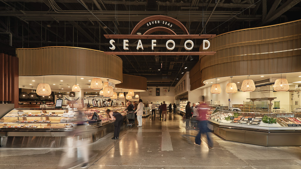 A large room with people and food.