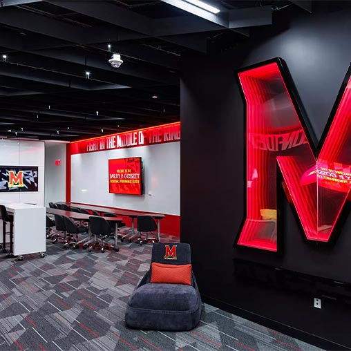 A room with a red screen and chairs.