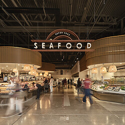 A large room with people and food.