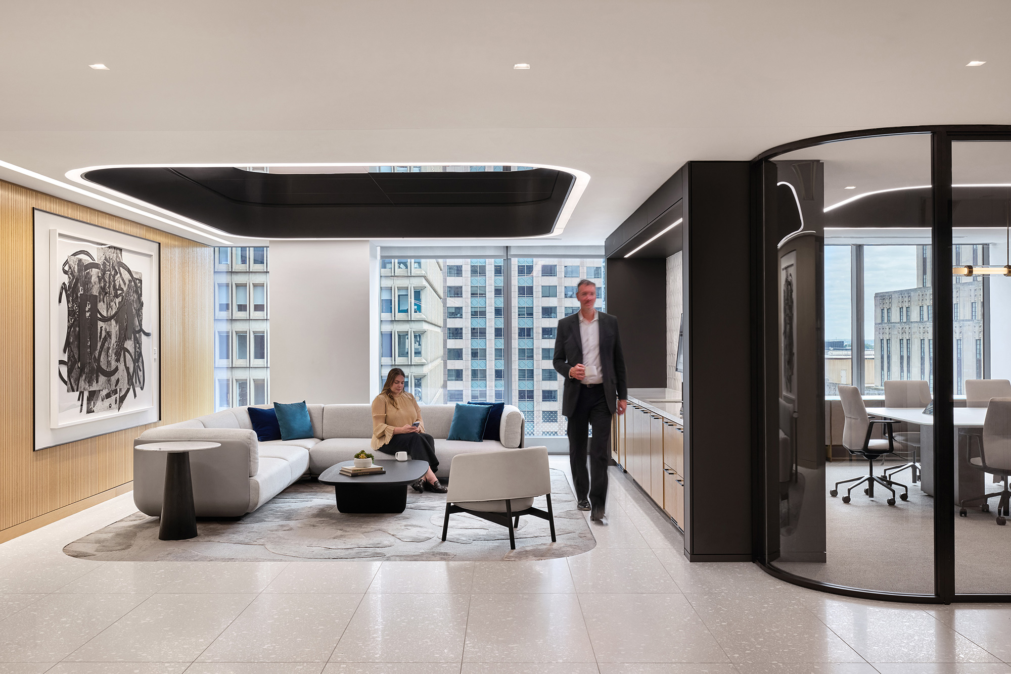 A man and a woman in a room with a large glass wall.