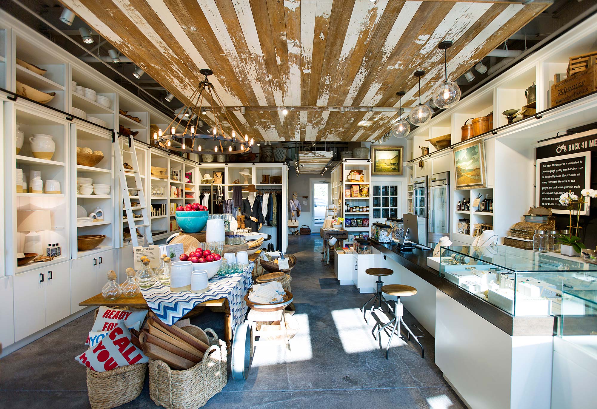 A large room with a table and chairs and a large ceiling with many objects.