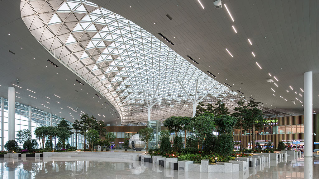 A large indoor mall with a pool.