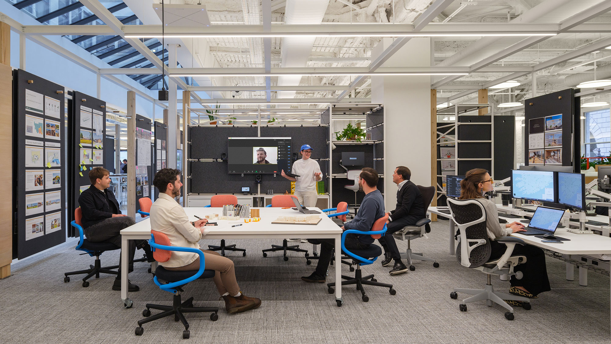 A group of people sitting at a table with computers.