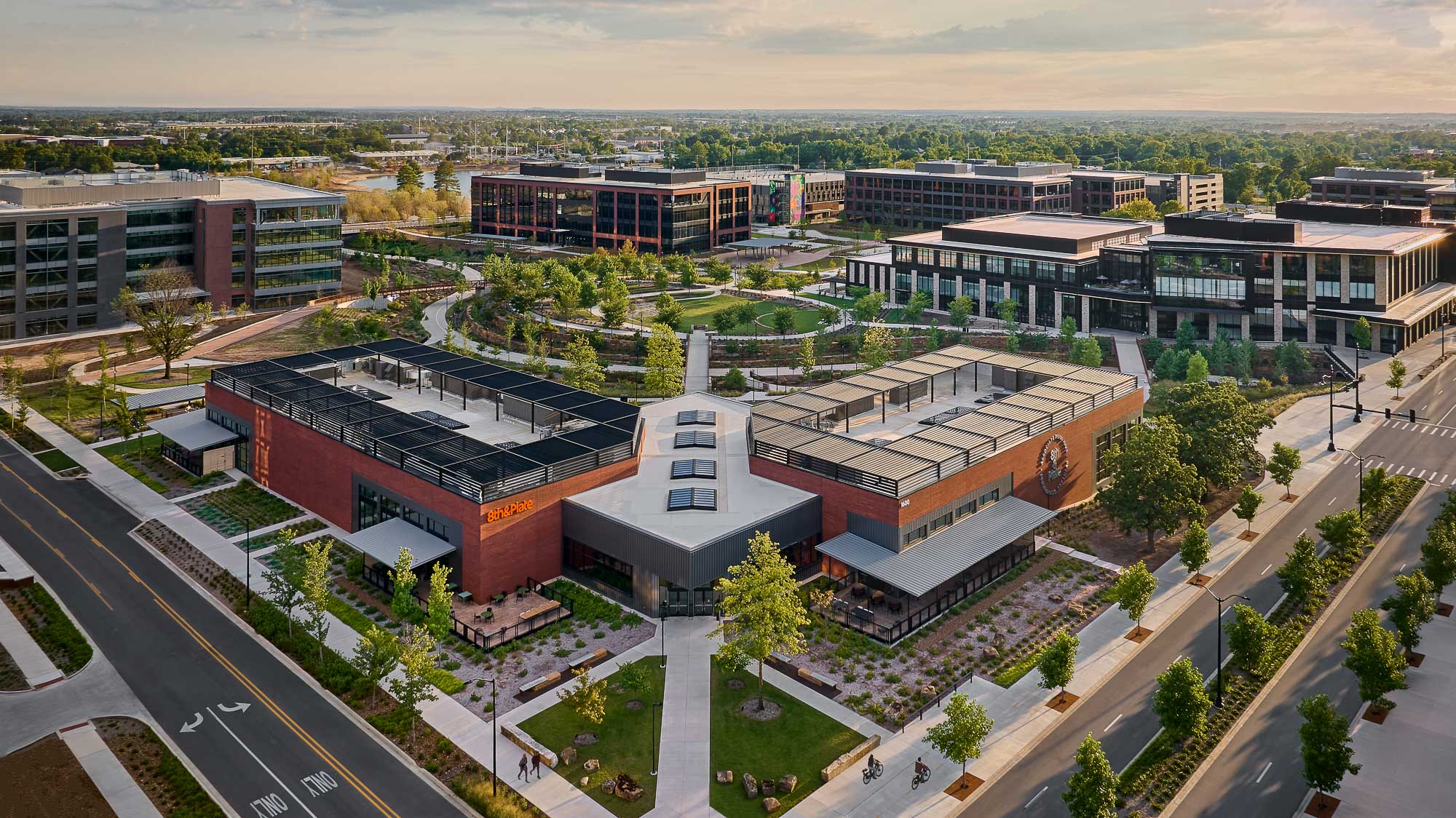 A large building with a courtyard and trees in front of it.