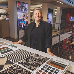 A man standing behind a table.