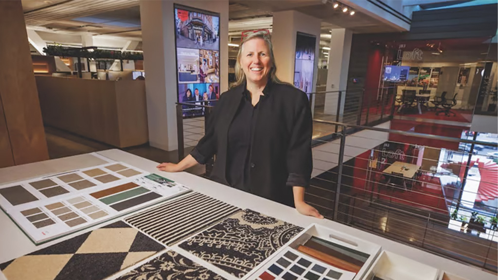 A person standing next to a display.
