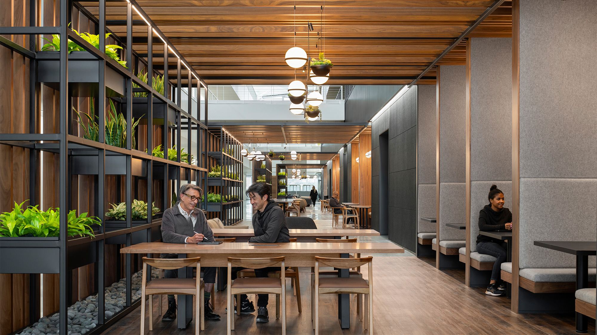 A group of people sitting at a table in a building.