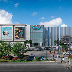 A large glass building with a sign on it.
