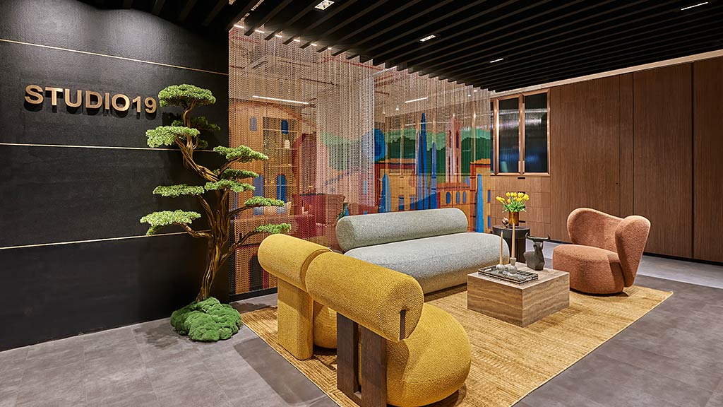 A room with a couch and chairs.