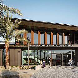 A building with a few people walking out front.