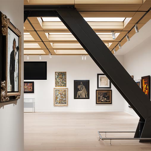 A staircase with pictures on the wall.