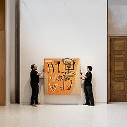 A man and a woman looking at a sign.